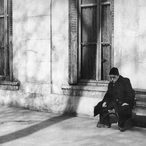 G. I. Gurdjieff sitting on step
